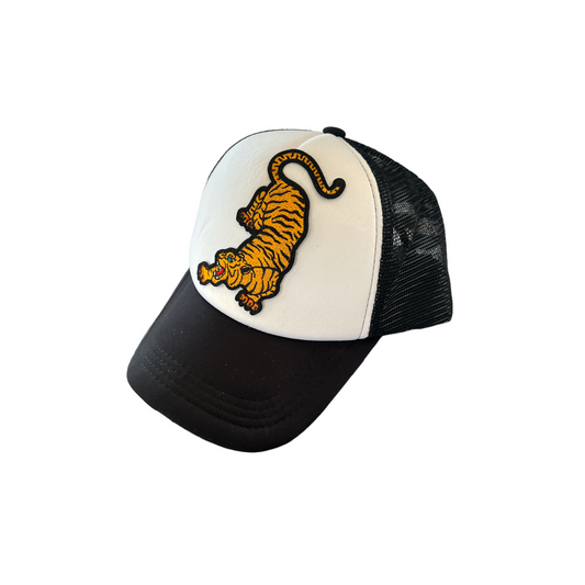 Black and white trucker hat with an embroidered tiger patch, adjustable snapback closure, and breathable mesh back, perfect for casual wear, outdoor activities, or making a bold fashion statement.